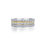 A close-up of the 3-Piece Eternity Ring Set by Lafonn reveals a stunning arrangement: a top band with round diamonds, a middle gold band adorned with baguette diamonds, and a bottom band featuring smaller round diamonds in a silver setting. The rings have a mesmerizing sparkling appearance.