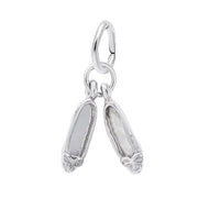 The image shows the Sterling Silver Pair of Ballet Shoes Accent Charm from Rembrandt Charms. The charm is crafted in sterling silver and features a detailed design of a pair of ballet shoes. It measures 0.17 inches by 0.5 inches (4.38 mm x 12.61 mm) and has the style number 0448. This charm is a perfect keepsake for dancers and ballet enthusiasts.