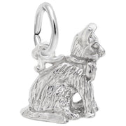 The Sitting Cat Charm in sterling silver from Rembrandt Charms showcases a detailed sitting feline with textured fur. The cat is adorned with a small collar and features an attached ring, allowing it to be used as a pendant or an addition to a charm bracelet. This piece boasts a vintage and elegant look.