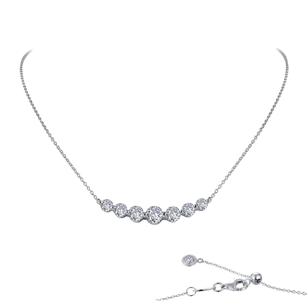The 7 Symbols of Joy Necklace by Lafonn is a delicate sterling silver piece bonded with platinum. It features seven evenly spaced, round-cut simulated diamonds set in a fine chain with an adjustable clasp, as shown in detail in the bottom right corner of the image.