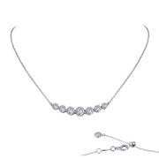 The 7 Symbols of Joy Necklace by Lafonn is a delicate sterling silver piece bonded with platinum. It features seven evenly spaced, round-cut simulated diamonds set in a fine chain with an adjustable clasp, as shown in detail in the bottom right corner of the image.