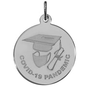 The Covid-19 Graduation Charm in Sterling Silver by Rembrandt Charms is a silver pendant that showcases an engraved design of a graduation cap, face mask, and diploma, with "COVID-19 PANDEMIC" inscribed around the image.