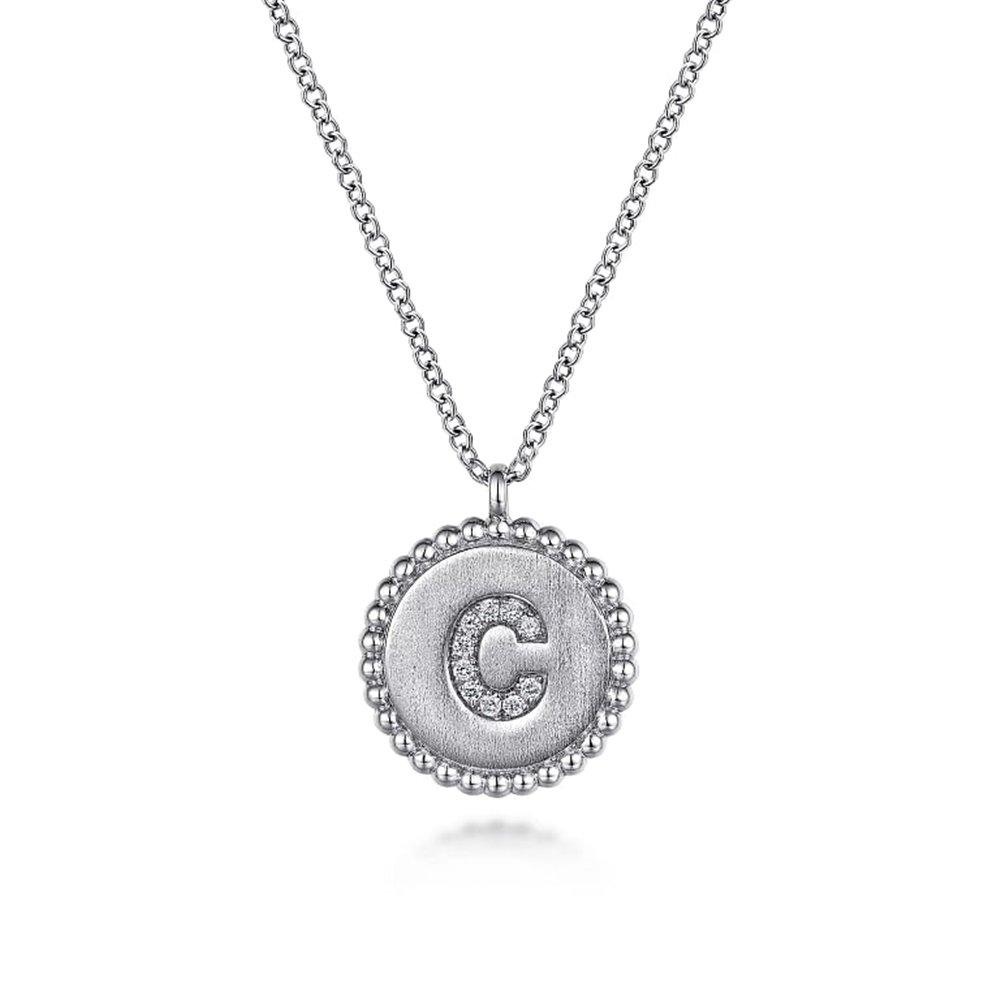 The 925 Sterling Silver Diamond Bujukan Initial C Necklace from Gabriel & Co features a silver pendant adorned with a raised, diamond-encrusted letter "C." Crafted from 925 sterling silver, the pendant boasts a beaded edge and is suspended from a delicate chain. This elegant design beautifully showcases the sparkling initial at its center.