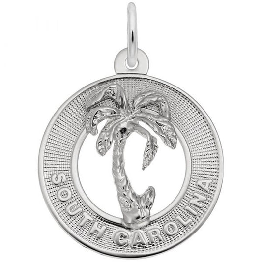 The South Carolina Charm in sterling silver by Rembrandt Charms features a palm tree at the center, encircled by a textured border. Inscribed with the words "SOUTH CAROLINA" at the bottom, this charm celebrates the essence of the Palmetto State.