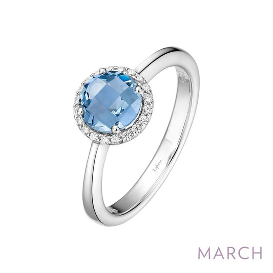 The March Birthstone Ring by Lafonn showcases a round, blue gemstone encircled by small clear diamonds. The backdrop is white, with "MARCH" elegantly inscribed in light purple text at the bottom right corner. Ideal for those celebrating their birthstone for March.