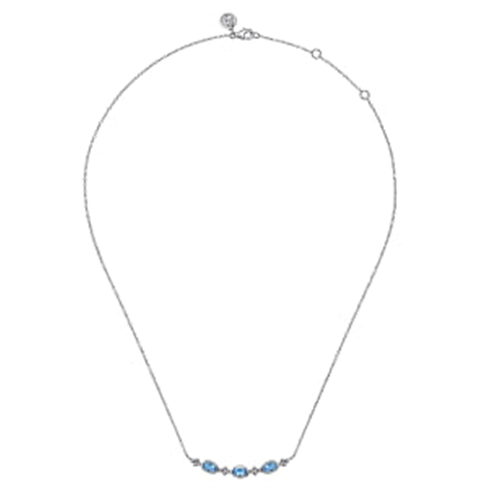 The 925 Sterling Silver Bujukan Blue Topaz Bar Necklace by Gabriel & Co features a delicate thin chain adorned with small Swiss Blue Topaz gemstones, evenly spaced near the center. Its minimalist and elegant design makes it perfect for everyday wear or special occasions, with an adjustable clasp to vary the length for a customized fit.