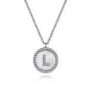 Discover the dazzling elegance of Gabriel & Co’s 925 Sterling Silver Diamond Bujukan Initial L Necklace. The silver necklace features a circular pendant with a textured surface and a capital "L" encrusted with small diamonds, all edged by an intricate beaded design.