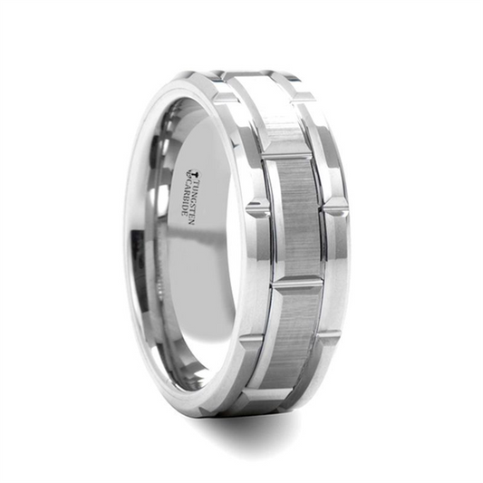 The Thorsten WARWICK Beveled Tungsten Carbide Wedding Band is a stunning silver tungsten carbide ring, featuring a brushed center and polished beveled edges. Inside, "Tungsten Carbide" is elegantly engraved. This exquisite ring showcases an intricate pattern with square grooves along the middle, making it perfect for any special occasion.