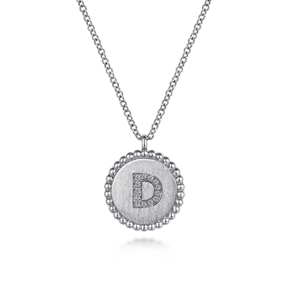 The Gabriel & Co 925 Sterling Silver Diamond Bujukan Initial D Necklace features a round pendant adorned with a "D" initial set in small, sparkling diamonds. The pendant's border boasts a Diamond Bujukan beaded edge, and it gracefully hangs from a delicate chain, showcasing an elegant and sophisticated design.