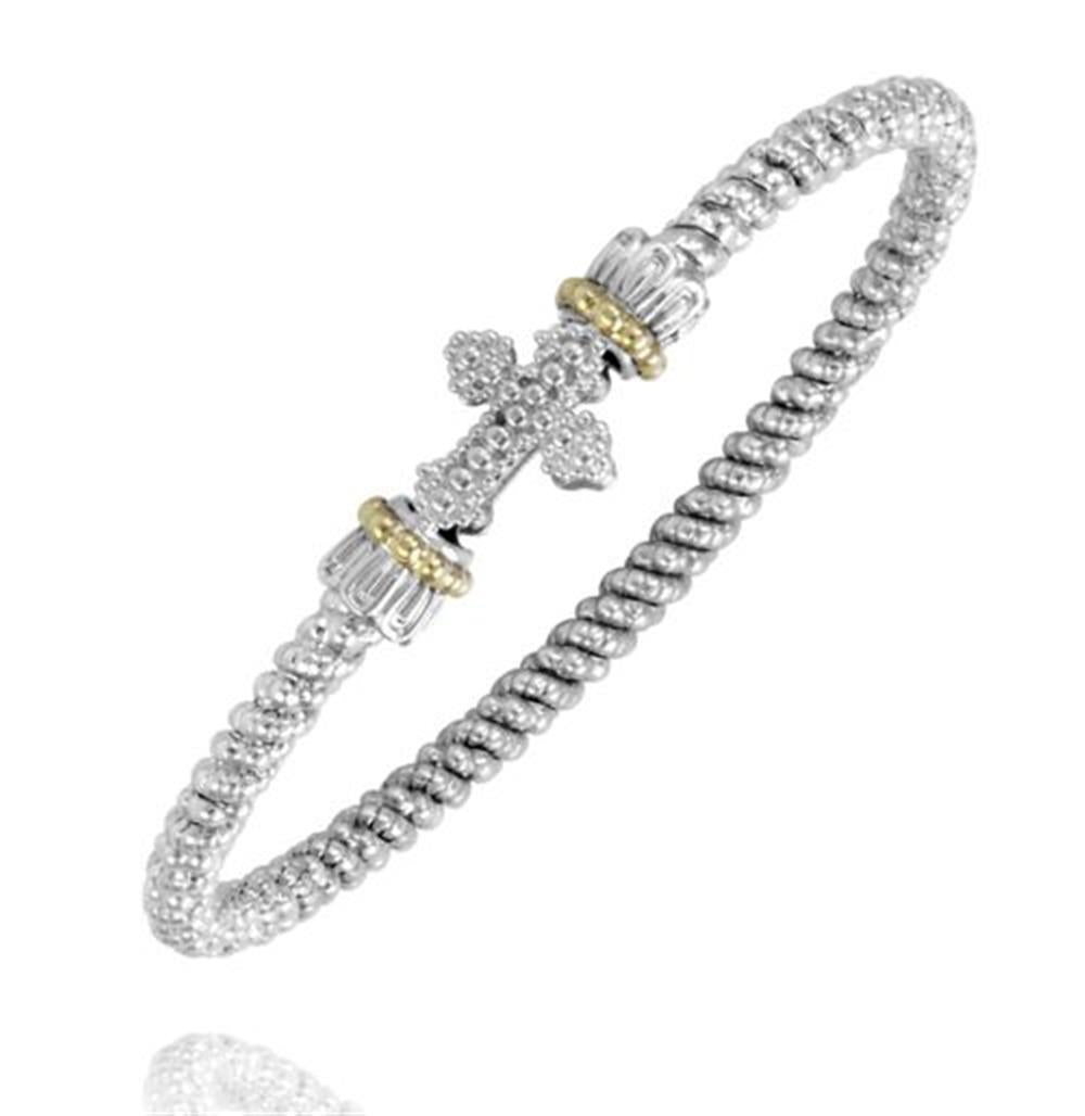 Experience the exquisite design of the Alwand Vahan Jewelry 3MM Two-Tone Closed Band (Size B4, model 23171/03). This stunning silver bracelet showcases a textured, ribbed band and a central ornate cross embellishment adorned with small gemstones. The cross is flanked by decorative cylindrical accents featuring elegant gold-toned borders, resulting in a polished and intricate design.