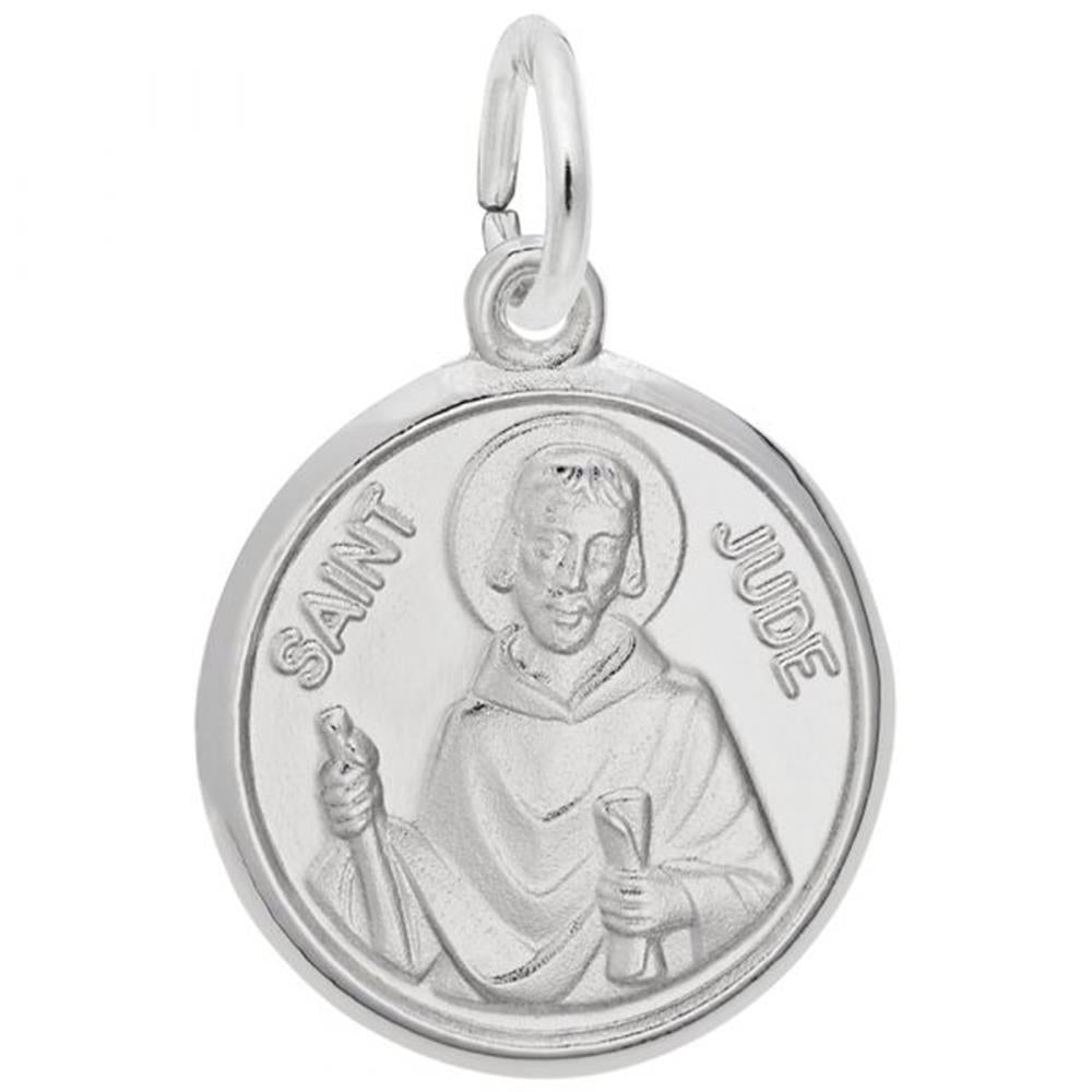 The Rembrandt Charms St. Jude Charm in sterling silver features a round design with an engraved image of Saint Jude holding a club and a scroll. The words "SAINT JUDE" encircle the image along the outer edge of the pendant, and it has a small loop at the top for easy attachment to a chain, making it a timeless addition to any jewelry collection.