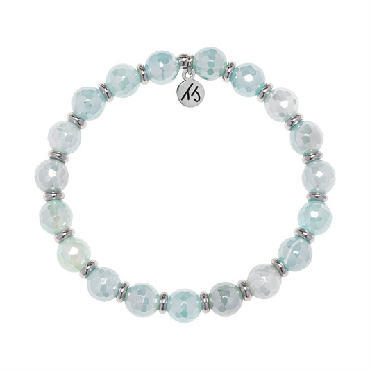 From T Jazelle’s Silver Empowered Elegance Collection, the Aqua Agate Gemstone Bracelet features round faceted pale blue and white stones with silver spacers and a signature "KS" charm.