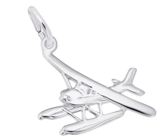 The Rembrandt Charms Seaplane Charm in Sterling Silver features detailed wings, pontoons, and a loop at the top, making it perfect for attaching to a bracelet or necklace.
