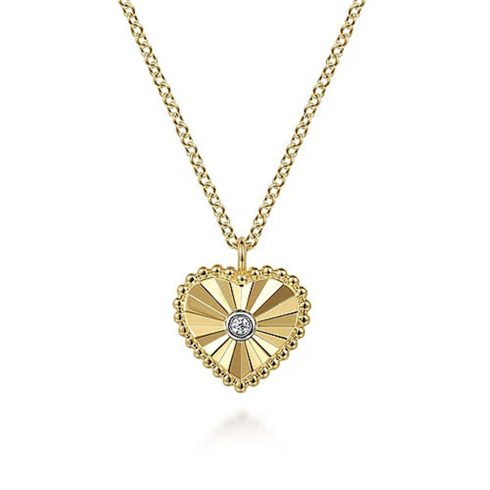 The Gabriel & Co 14K Gold Diamond and Heart Pendant Necklace boasts a central diamond pendant with sunray patterns radiating from the stone. The heart is elegantly encircled by intricate Bujukan beading, and the detailed link design of the chain flawlessly complements the pendant.
