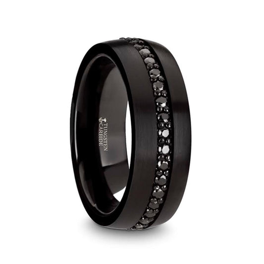 The Black Tungsten with Black Sapphires Band by Thorsten features a central band adorned with small black sapphires. The stones are set in a single line that encircles the entire ring, contrasting beautifully against the smooth, matte finish of the tungsten band.