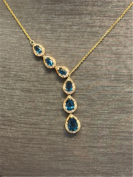Ryan Gems Pear shaped London Blue Topaz Drop pendant in 14k yellow gold showcases five teardrop-shaped blue topaz drops, each encircled by clear stones and arranged vertically and at an angle on a textured gray background.