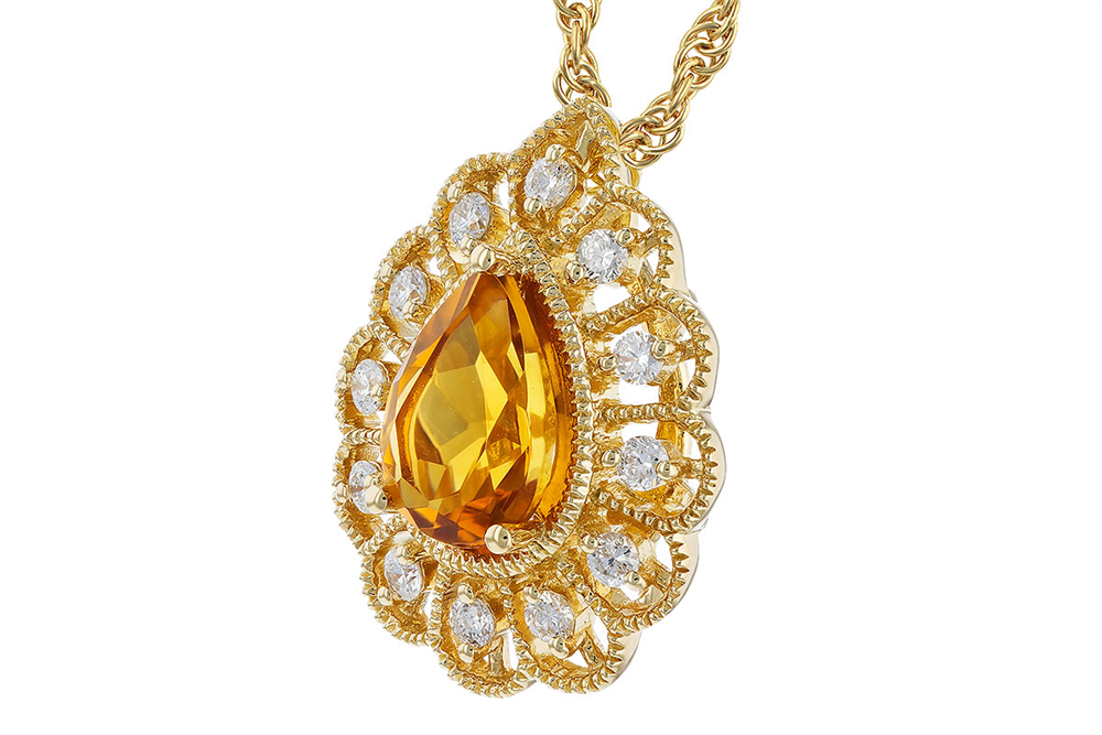 The Citrine and Diamonds 14K Yellow Gold Necklace by Allison Kaufman showcases a stunning pear-shaped citrine gemstone at its center, encircled by a halo of diamond accents. The pendant features intricate metalwork details and is elegantly attached to a twisted gold chain.
