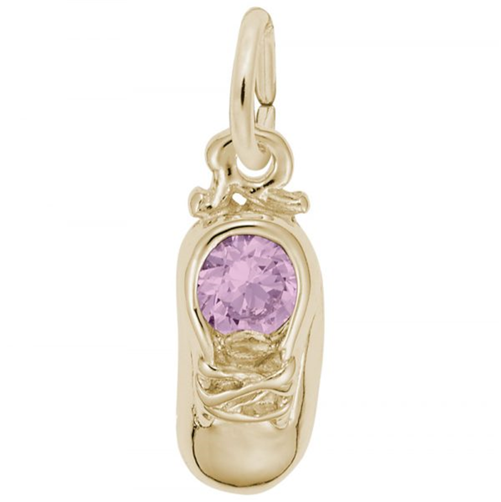 The image shows the 10K Yellow Gold October Baby Shoe Charm from Rembrandt Charms. The charm is crafted in 10K yellow gold and features a detailed baby shoe with a pink tourmaline-colored stone. It measures 0.2 inches by 0.43 inches (5 mm x 11 mm) and has the style number 2734-010. This charm is a perfect keepsake for commemorating the birth of an October baby.