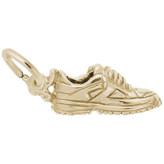 The **Sneaker Charm / Gold Plated Sterling Silver**, by **Rembrandt Charms**, is a small, intricately designed charm resembling a sneaker. It features detailed laces, stitching, and textured soles, along with a loop at the back for easy attachment to a chain or jewelry piece.