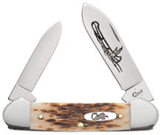 The Amber Bone Peach Seed Jig Canoe by W.R. Case & Sons Cutlery Co. is a pocket knife with two partially opened stainless steel blades, one adorned with an engraving. The handle features a textured brown and cream Amber Bone pattern, accented with metal bolsters at both ends, and proudly displays the "Case" logo.