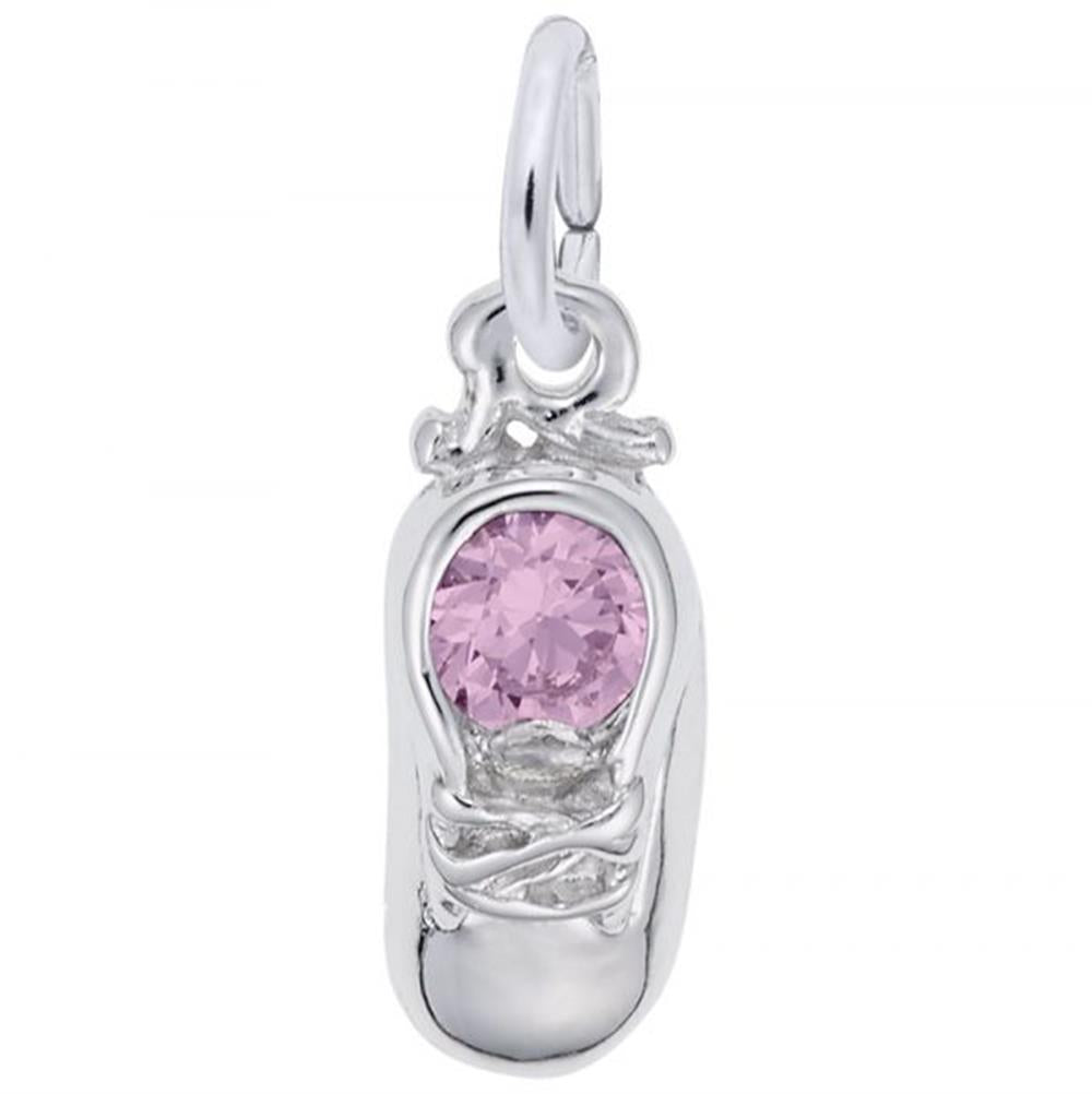 A close-up image of an October Baby Shoe Charm / Sterling Silver with intricate detailing, featuring a pink gemstone set at the center. The charm, from Rembrandt Charms and available at Avonlea Jewelers, has a polished finish and a loop at the top for attaching to a bracelet or necklace.