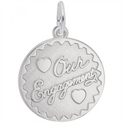 The Engravable Engagement Disc Charm in sterling silver by Rembrandt Charms features a round design with scalloped edges, two heart motifs, and the engraved words “Our Engagement” in elegant cursive—making it a romantic and beautifully personalized engagement keepsake.