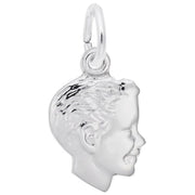 The Boys Head Small Charm by Rembrandt Charms is a sterling silver pendant that showcases the profile of a smiling child's head, complete with detailed features and textured hair. This elegant charm is attached to a small circular ring, making it perfect for threading onto either a necklace or bracelet.