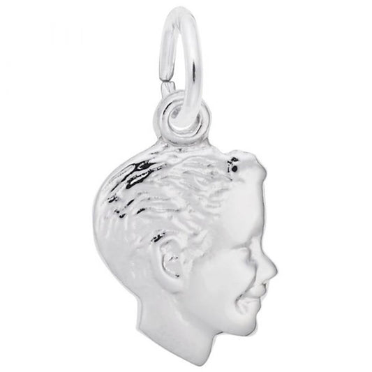 The Boys Head Small Charm by Rembrandt Charms is a sterling silver pendant that showcases the profile of a smiling child's head, complete with detailed features and textured hair. This elegant charm is attached to a small circular ring, making it perfect for threading onto either a necklace or bracelet.