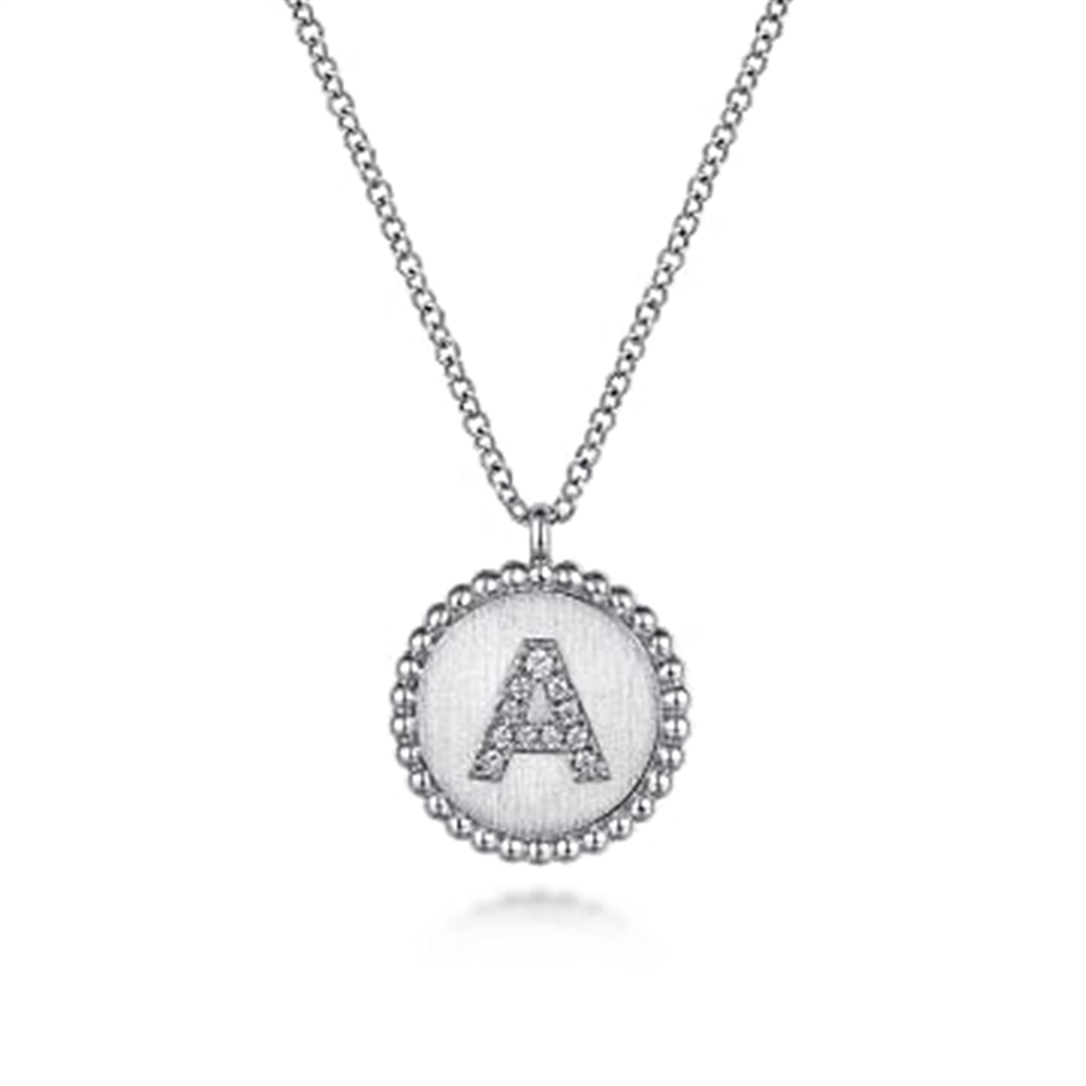 Introducing the Gabriel & Co 925 Sterling Silver Bujukan Diamond Initial "A" Necklace, serial number S. This exquisite piece features a round pendant with a beaded edge, showcasing the letter "A" encrusted with small, sparkling crystals and is delicately suspended from a fine chain.