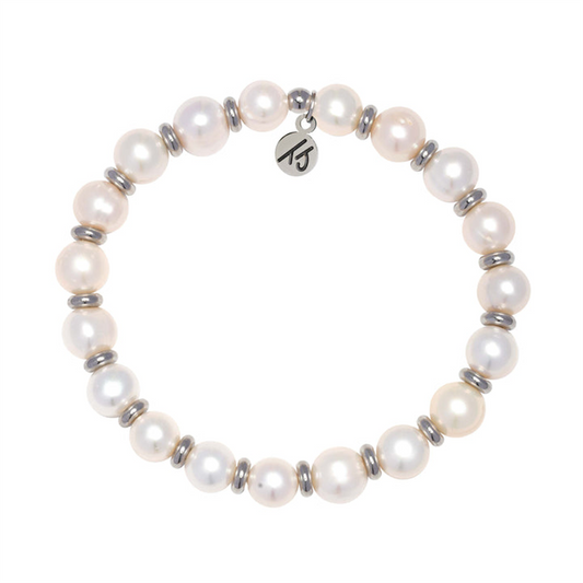 The T Jazelle Silver Empowered Elegance Collection Pearl Gemstone Bracelet features white pearls, silver spacer beads, and a round "TJ" logo charm—an elegant accessory that expresses empowerment.