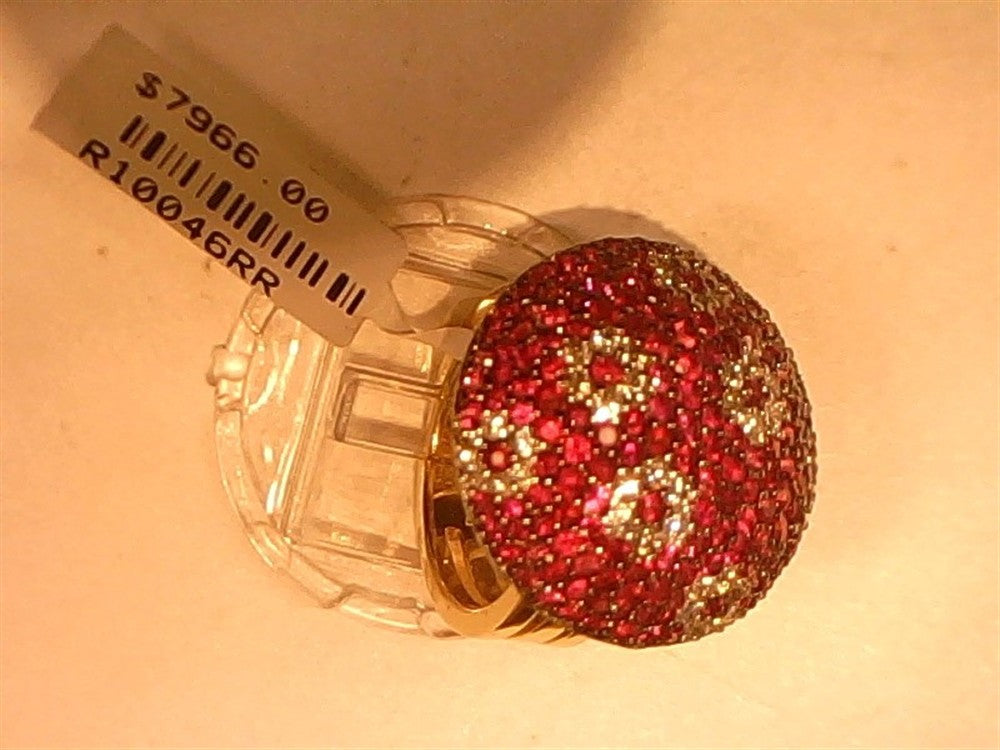 The Ryan Gems Diamond & Ruby dome ring, crafted in 14k yellow gold and size 6.5, is showcased under warm lighting. A price tag reading "$7966.00" with a barcode and item code is attached to the gem-encrusted piece.