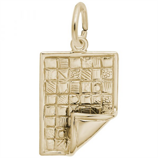 The Rembrandt Charms gold-plated sterling silver Quilt Charm is designed to resemble a patchwork quilt, featuring various textured squares and a folded corner. The charm is intricately crafted, complete with a loop at the top for attaching to a chain or bracelet.