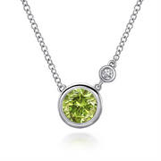 Experience the elegance of the Gabriel & Co 925 Sterling Silver Peridot and Diamond Pendant Necklace. This exquisite piece showcases a round, green Peridot gemstone set in sterling silver, complemented by a small, clear diamond above it. The design is minimalist yet sophisticated, highlighting the vibrant stones beautifully.
