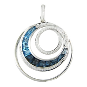 A silver pendant from Bellarri's Blue Topaz and Diamond Pearl Enhancer collection features an elegant spiral design. The spiral includes segments inlaid with shimmering blue topaz gemstones. The intricate metalwork adds a sophisticated touch to the modern and stylish accessory.