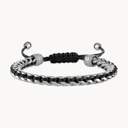 Introducing the Stainless Steel and Black Cord Sliding Bolo Bracelet by Bulova Watch Company—a stylish accessory featuring a sleek silver chain intertwined with black rope. This modern bracelet is adjustable with silver bead accents and a sliding bolo closure, ensuring a secure fit for any occasion.
