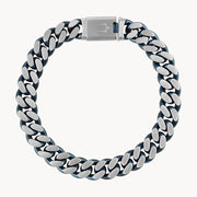 A bold men's accessory, the Bulova Watch Company Curb Chain Bracelet features chunky stainless steel links and a box clasp, shown in a circular shape on a plain white background.