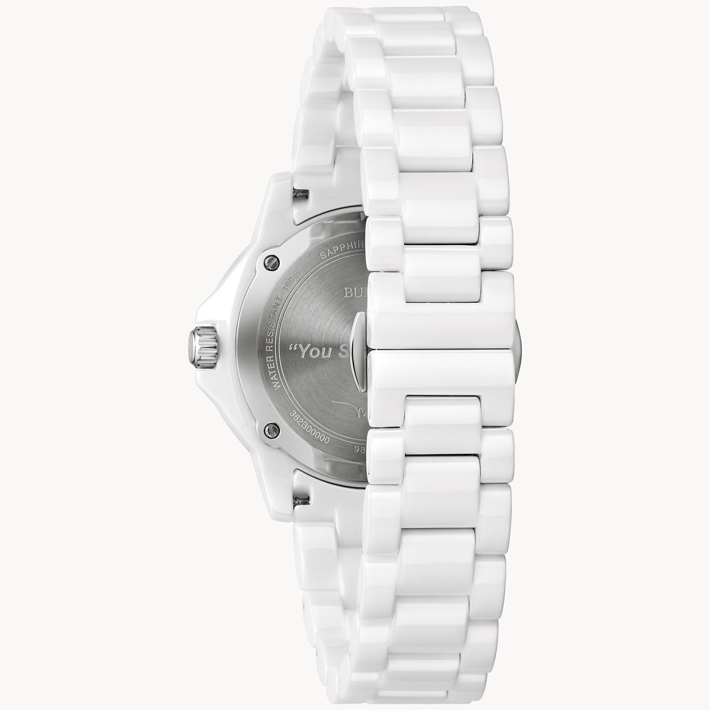 A Bulova Marc Anthony Marine Star White Dial Women's Watch by Bulova Watch Company is shown from the back, displaying a silver engraved case back, left-side crown, and a white ceramic link-style bracelet.