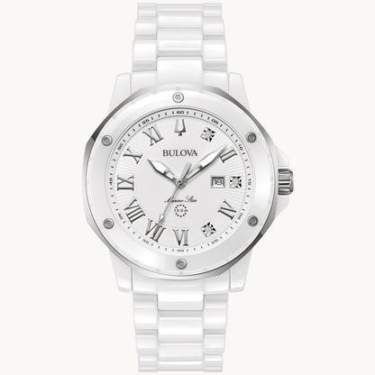 The Bulova Marc Anthony Marine Star White Dial Women's Watch by Bulova Watch Company features a metallic bezel, Roman numerals, diamond hour markers, date window, white ceramic bracelet, and a modern design.