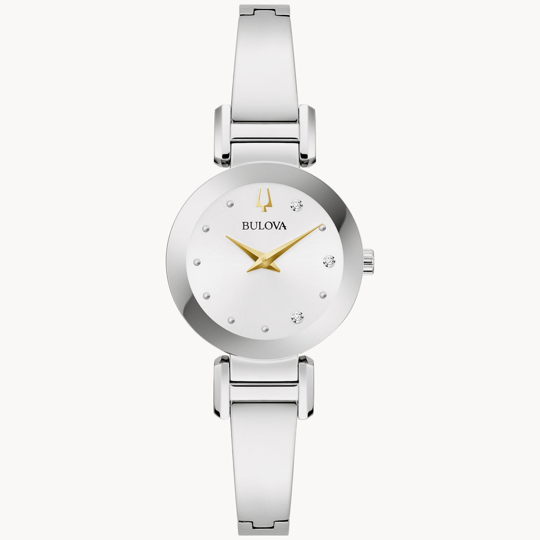 The Marc Anthony "Valió la Pena" Women's Watch with Diamonds by Bulova features a sleek silver design with a minimalist round dial accented by sparkling diamonds. The dial includes small, diamond-like hour markers, a gold-toned logo at the 12 o'clock position, and gold-toned hour and minute hands. The polished silver metal bracelet adds the perfect finishing touch to this elegant timepiece.