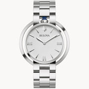 The Bulova Rubaiyat Women's White Dial Stainless Steel Watch by Bulova Watch Company features a silver-tone case, metallic band, minimalist white face with silver Roman numerals and hands, quartz movement, and a blue accent on the crown.