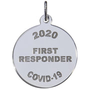 The Covid-19 First Responders Charm in Sterling Silver by Rembrandt Charms is a beautifully crafted round charm, elegantly engraved with "2020 FIRST RESPONDER COVID-19." It features a small loop at the top, making it perfect for attaching to a chain or string. This meaningful piece honors courage and dedication during challenging times.