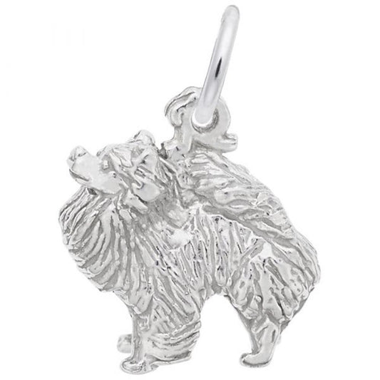 A detailed image of the Sterling Silver Pomeranian Dog Charm by Rembrandt Charms. This charm features an intricately detailed Pomeranian dog, measuring 0.48 inches by 0.48 inches (12.17 mm by 12.19 mm). The charm has a polished sterling silver finish, perfect for adding a touch of canine charm to any bracelet or necklace. Style number 1758.