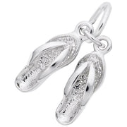 A close-up image of the Sandals Charm by Rembrandt Charms, crafted from sterling silver to resemble a pair of flip-flops. The charm features intricately detailed straps and textured soles, with a small loop at the top for attaching to a bracelet or necklace.