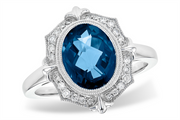 The Allison Kaufman "London Blue Topaz and Diamonds 14k White Gold Ring" showcases a silver finish with a central London blue topaz gemstone surrounded by small, sparkling diamonds in an ornate, vintage-inspired design that exudes elegance.