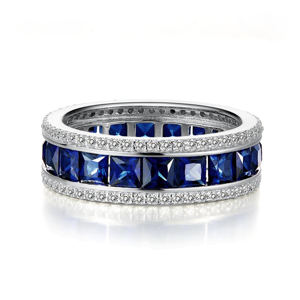The Lafonn Vintage Inspired Eternity Band Ring showcases two rows of square blue gemstones, bordered by small simulated diamonds on both edges. The reflective surface around the gemstones highlights their deep blue color, crafting a timeless classic piece.