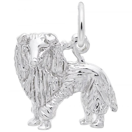 The Rembrandt Charms Sheltie Dog Charm in sterling silver boasts an intricate design that mimics the detailed fur patterns of a Sheltie or Collie, complete with a small loop at the top for easy attachment to jewelry.