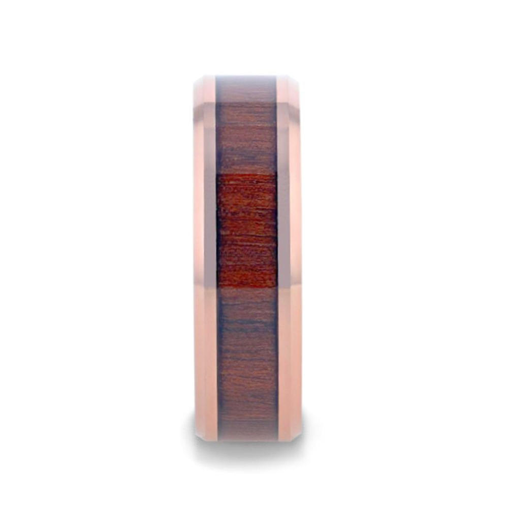 The DYLAN Rose Gold Plated Koa Wood Inlaid Tungsten Men's Wedding Band by Thorsten features a polished rose gold plated exterior and a centered inlay of dark Koa wood texture. This ring boasts a modern and elegant design, seamlessly blending metallic shine with natural wood grain. The image depicts the band in an upright position against a white background.