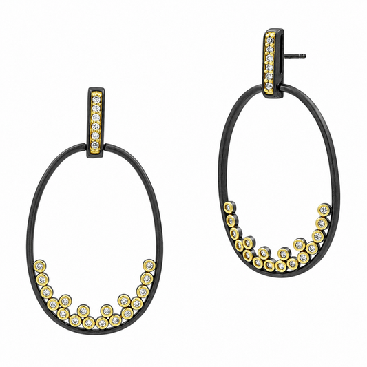 The Freida Rothman Armor of Hope Open Oval Hoop Earrings (VFYKZE26) feature black metal, gold accents, and small clear stones on the bottom and vertical bar. One earring is shown front-facing, the other at an angle.