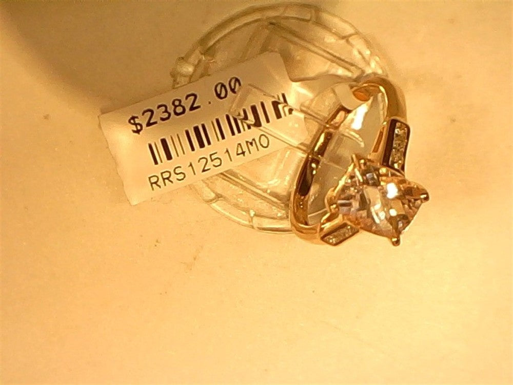 The Ryan Gems Cushion Cut Morganite Ring, crafted in 14k rose gold and size 7, features a dazzling gemstone with accent stones, displayed elegantly on a stand with a $2382.00 price tag against a light background.