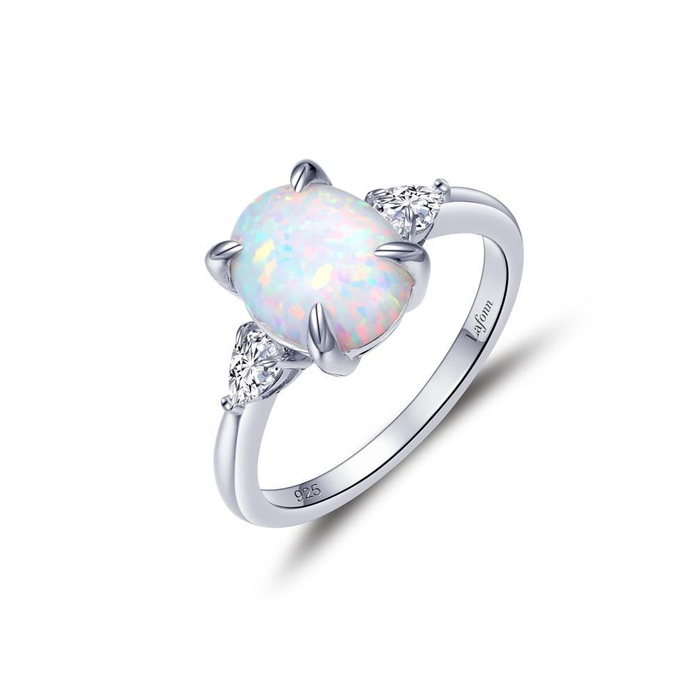 The Lafonn Three-Stone Engagement Ring showcases a large, oval-shaped opal gemstone with a prismatic, iridescent quality set in a four-prong setting. Flanked by two smaller, triangular clear stones, this silver ring features a smooth and polished band.
